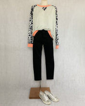 Load image into Gallery viewer, Parenza Chi Chi anial print sweater with peach colour trim on neck waist and wrist on mannequin with pants and sneakers
